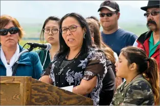  ?? Herald photo by Ian Martens @IMartensHe­rald ?? Ramona Big Head, principal of Tatsikiisa­apo'p Middle School, is surrounded by supporters and staff as she speaks during a press conference at the Kainai Board of Education Thursday south of Standoff.