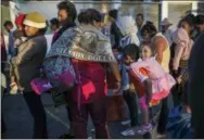  ?? AP PHOTO/RODRIGO ABD ?? Migrants stand in a line waiting for donated food in Tijuana, Mexico, on Sunday as they try to reach the U.S.