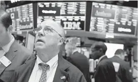  ?? RICHARD DREW/ASSOCIATED PRESS ?? Trader Frederick Reimer works on the floor of the New York Stock Exchange, Tuesday, when the Dow Jones industrial average fell as much as 500 points in early trading.