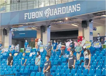  ??  ?? Fans sing the national anthem prior to the CPBL game between Rakuten Fubon Guardians and Uni-Lions at Xinzhuang Baseball Stadium on Friday in New Taipei City, Taiwan.