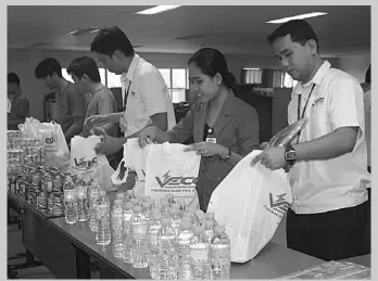  ??  ?? VECO employees preparing relief goods for victims of typhoon Pablo.