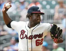  ?? / AP-John Amis ?? Braves’ Touki Toussaint pitches against the Marlins during the first inning of the first game in a double header in Atlanta on Monday.