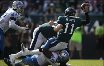  ?? MATT ROURKE — THE ASSOCIATED PRESS ?? Given Carson Wentz’s injury history, seven sacks this season, including this one by the Lions’ Damon Harrison last Sunday, are too many for the Eagles’ offense to be giving up.