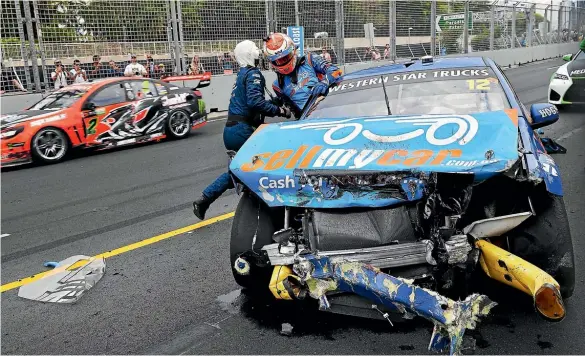  ??  ?? Fabian Coulthard is helped from his car after a crash.