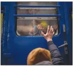  ?? (AP/Emilio Morenatti) ?? Stanislav says goodbye to his 2-year-old son, David, and wife, Anna, on March 3 after they boarded a train that would take them to Lviv, from the station in Kyiv, Ukraine. Stanislav stayed to fight as his family sought refuge in a neighborin­g country.