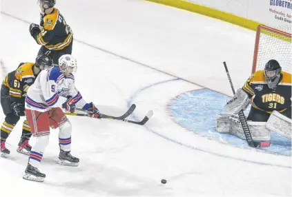  ?? JASON SIMMONDS/JOURNAL PIONEER ?? Summerside Western Capitals rookie Bennett MacArthur, 9, battles for position with the Campbellto­n Tigers’ Sam McKinney, 61, while attempting to redirect a shot on goaltender Tristan Gray during a Maritime Junior Hockey League game at Eastlink Arena on Nov. 9. Also in the play is the Tigers’ Elliott St-Pierre.