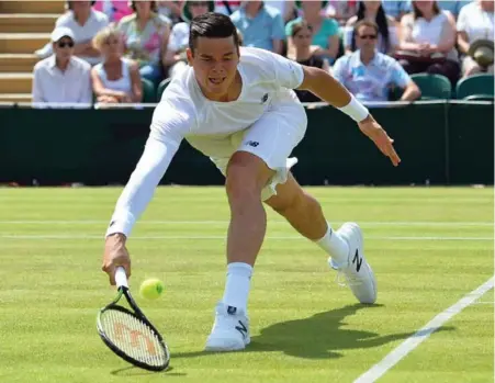  ?? GLYN KIRK/AFP/GETTY IMAGES ?? Canada’s Milos Raonic returns to Australia’s Nick Kyrgios during third-round play at Wimbledon on Friday. Raonic lost, 5-7, 7-5, 7-6, 6-3.