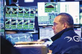  ?? DAVID L. NEMEC/NEW YORK STOCK EXCHANGE VIA AP ?? Specialist Anthony Matesic works on the trading floor Monday. Stocks rallied in afternoon trading on Wall Street following seven weeks of declines.