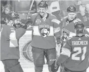  ?? PATRICK FARRELL/MIAMI HERALD ?? Panthers center Aleksander Barkov (second from left) celebrates his second-period goal with teammates.