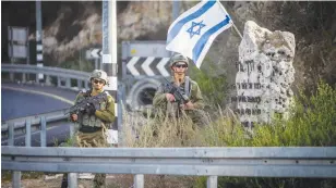  ?? (Nasser Ishtayeh/Flash90) ?? SECURITY FORCES guard close to where soldiers shot a Palestinia­n man in a suspected ramming attack near the settlement of Havat Gilad yesterday.