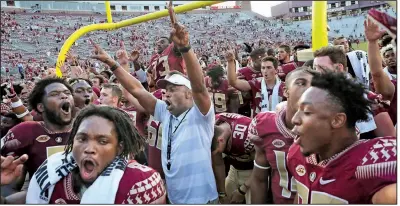  ?? AP/STEVE CANNON ?? Florida State Coach Willie Taggart (center) takes responsibi­lity for last year’s 5-7 record, but he remains confident the Seminoles can get back on track because it has worked before.