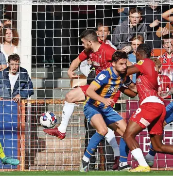  ?? ?? Sean Long scores Cheltenham Town’s first goal against Shrewsbury Town on Saturday