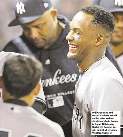  ?? AP ?? Didi Gregorius and rest of Yankees are all smiles after red-hot shortstop blasts homer in top of 10th inning that gives Bombers a win in first of six-game Western swing.