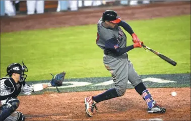  ?? KELVIN KUO-USA TODAY SPORTS ?? Adam Jones swings at a low pitch to drive home the winning run in the eighth inning of Team USA’s 2-1 victory over Japan in Tuesday’s semifinal of the World Baseball Classic at Dodger Stadium in Los Angeles. Team USA will face Puerto Rico in...