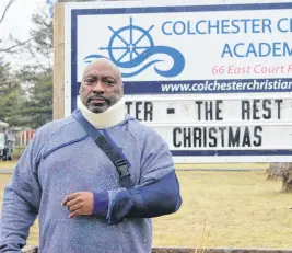 ?? ?? Wallace Fowler stands in front of Colchester Christian Academy. Fowler says he was injured in an altercatio­n with police. SALTWIRE