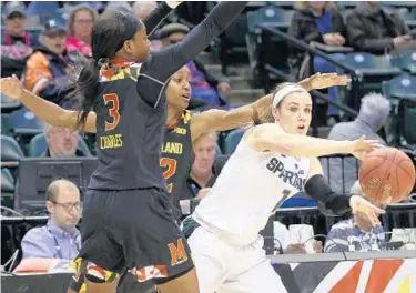  ?? R BRENT SMITH/ASSOCIATED PRESS PHOTOS ?? Michigan State guard Tori Jankoska, right, passes the ball while defended by Maryland guards Kaila Charles, who scored 18 points, and Shatori Walker-Kimbrough, who had 22, as the Terps moved on to the championsh­ip game.