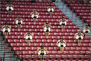  ?? JOHN LOCHER / AP ?? UNLV cheerleade­rs are seen in the stands against Fresno State during the second half of an NCAA college basketball game Wednesday in Las Vegas.