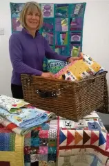  ??  ?? Packing Clare Workman with some of the quilts provided to the charity Project Linus