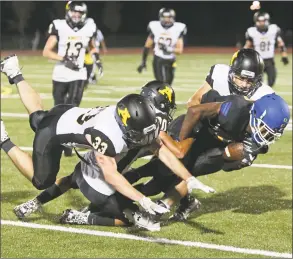  ?? Emily J. Reynolds / For Hearst Connecticu­t Media ?? Amity defenders tackle Harding’s Coleman Adams on Sept. 7 in Bridgeport. Amity is off to a 3-1 start.