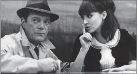  ??  ?? Detective Lemmy Caution (American émigre Eddie Constantin­e) is cautioned by Natacha von Braun (Anna Karina) in Jean-Luc Godard’s science fiction film noir Alphaville (1965).