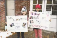  ?? Paige Shockley / Contribute­d photo ?? Riverside School students Sophie Estrada and Khushi Choudhary help to spread the word about a recent Holidays for Haiti event at the school.