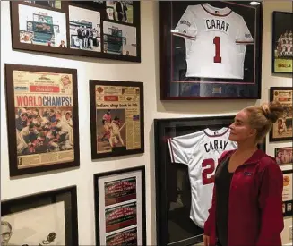  ?? PHOTO BY STEVE HUMMER ?? Skip Caray’s widow, Paula Caray, in the basement of her Atlanta home, flanked by memories of 1995 and other seasons.