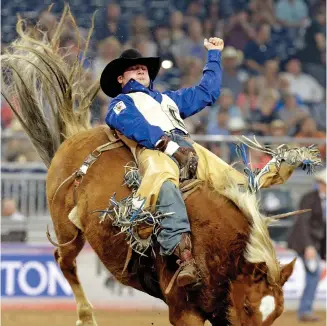  ?? Houston Chronicle ?? Kaycee Feild of Spanish Fork, Utah, competes in bareback riding at RodeoHoust­on.