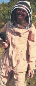  ??  ?? Reporter Molly MilehamCha­ppell prepares to get close to the bees