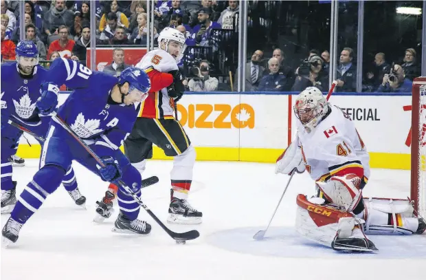  ?? JACK BOLAND / POSTMEDIA NEWS ?? John Tavares is unable to stuff the puck by Calgary Flames goalie Mike Smith in Monday’s game at Scotiabank Arena.