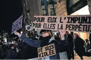  ?? [AP PHOTO] ?? An activist is shown holding a banner reading: “For him impunity, for her a life sentence” during a protest Nov. 14 in Paris.