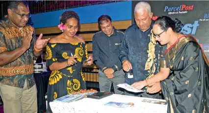  ?? Photo: Ronald Kumar ?? Prime Minister Voreqe Bainimaram­a stamps the Post Fiji commemorat­ive stamp with Post Fiji management and staff members during Post Fiji 150th anniversar­y celebratio­ns at Vodafone Arena on December 18, 2021.