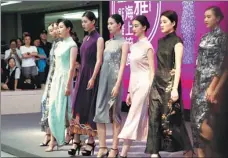  ?? PHOTOS BY GAO ERQIANG / CHINA DAILY ?? Qipao was believed to have been adapted from the traditiona­l robe worn by Manchu women during the Qing Dynasty (1644-1911).