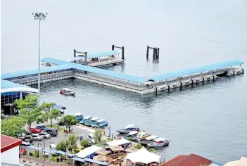  ??  ?? Not many boats and passengers are using the Labuan Internatio­nal Ferry Terminal following the reinforcem­ent of the Conditiona­l Movement Control Order.