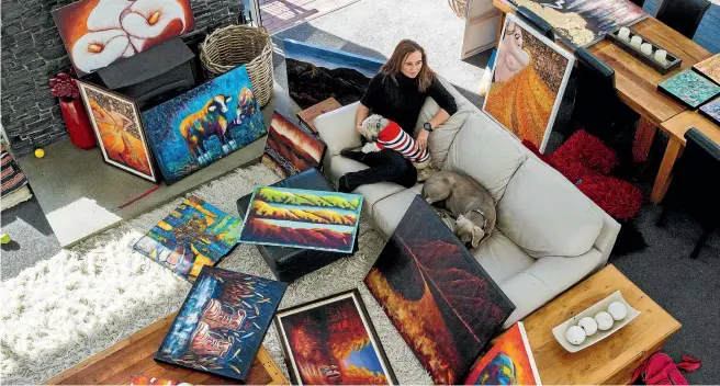  ?? PHOTO: WARWICK SMITH/STUFF ?? Hem Woollaston at home surrounded by her paintings and her two dogs.