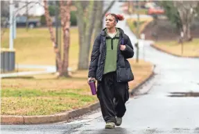  ?? KATHY KMONICEK/AP ?? Kailani Taylor-cribb walks through her neighborho­od in Asheville, N.C. Kailani hasn’t taken a single class in what used to be her high school since the height of the coronaviru­s pandemic. She vanished from the public school roll in Cambridge, Mass., in 2021 and has been, from an administra­tive standpoint, unaccounte­d for since then.