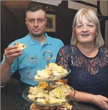  ?? Photograph: Kevin McGlynn. ?? David Evans and Carol Bain with her delicious scones ready for the high tea at the flower arranging event in the Argyllshir­e Gathering Halls.