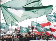  ?? AP PHOTO ?? Members of radical right-wing groups wave flags during a march by tens of thousands of people and hosted by President Andrzej Duda that marked 100 years since Poland regained independen­ce in Warsaw, Poland, Sunday.