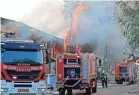  ?? AHMAD GHARABALI/AFP VIA GETTY IMAGES ?? Israeli firefighte­rs douse a burning factory in the town of Sderot.