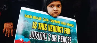  ?? File / Agence France-presse ?? ↑
A girl holds a placard during a demonstrat­ion against the Supreme Court verdict in the Ayodhya case in Chennai.