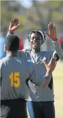  ?? Pictures: MARK ANDREWS ?? GOING BACK TO THEIR ROOTS: Mzwake Mzayiya, left, from Sarah Baartman congratula­tes team members during a game of kho-kho, a running game, against Nelson Mandela Bay University during the Provincial Indigenous Games held at Police Park on Saturday. Right, young participan­ts enjoy a game of diketo which is a hand to eye coordinati­on game.