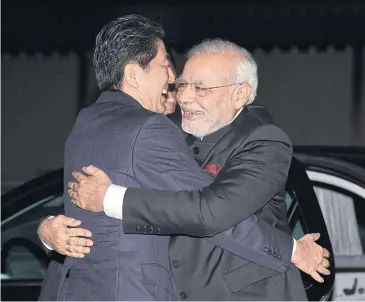  ?? AFP ?? India’s Prime Minister Narendra Modi embraces his Japanese counterpar­t Shinzo Abe upon his arrival at the State Guest House in Kyoto on Aug 30 last year. Mr Abe arrived yesterday for a weekend visit to India.