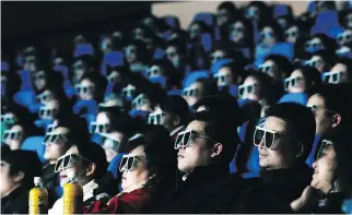  ?? CHINA PHOTOS/GETTY IMAGES ?? The audience watches a 3D movie at an IMAX theatre in Wuhan, China. Imax Private Theatre, the company’s home version, is targeting wealthy movie lovers in places like China and the Mideast.