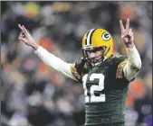  ?? PATRICK MCDERMOTT/GETTY IMAGES ?? Packers quarterbac­k Aaron Rodgers (12) celebrates after a touchdown on Jan. 2, 2022, in Green Bay, Wis.