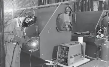  ??  ?? Branddyn Dupuis, Grade 10, works on a welding project in a trailer at Coalhurst High School. The school can’t afford its own permanent shop where students can learn trades so it built a mobile shop that travels around to several schools in the district.