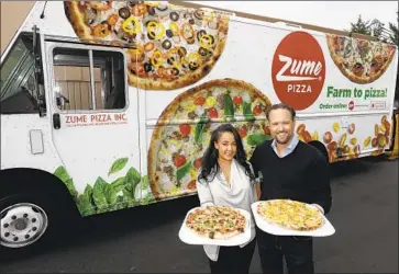  ?? Marcio Jose Sanchez Associated Press ?? IN JANUARY, Mountain View, Calif.-based Zume laid off half its staff and announced it would not deliver pizza but instead focus on industrial packaging. Above, co-founders Julia Collins and Alex Garden in 2016.