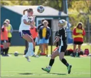  ?? PETE BANNAN — DIGITAL FIRST MEDIA ?? West Chester University senior Haley Mangiaruga heads the ball in the second half as East Stroudsbur­g’s Danielle Cary defends Tuesday afternoon at Rockwell Field.