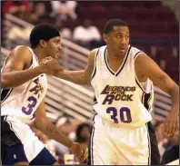  ?? (Arkansas Democrat-Gazette file photo) ?? Former Arkansas teammates Corliss Williamson (left) and Scotty Thurman, shown here during a 2002 Legends in the Rock charity game, will find themselves on opposite sides of the court today when Little Rock Parkview takes on Little Rock Christian in a 5A-Central clash. Thurman is head coach at Parkview and Williamson is an assistant at Christian.