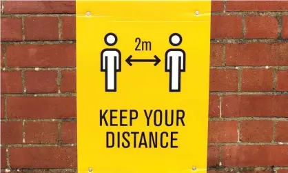  ?? Photograph: Stu Forster/Getty Images ?? A physical distancing reminder in Penarth, Wales. In the UK, some Tory MPs are pushing for theguidanc­e to be reduce to 1m.