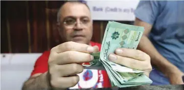  ?? R euters ?? ±
A money exchange vendor counts Lebanese pound banknotes at a currency exchange shop in Beirut, Lebanon.