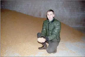  ?? ?? The Canadian Press
Farmer and Ukrainian military volunteer Oleh His (His is his name,) inspects his grain crop in western Ukraine. He has received grain storage sleeves from Canada.